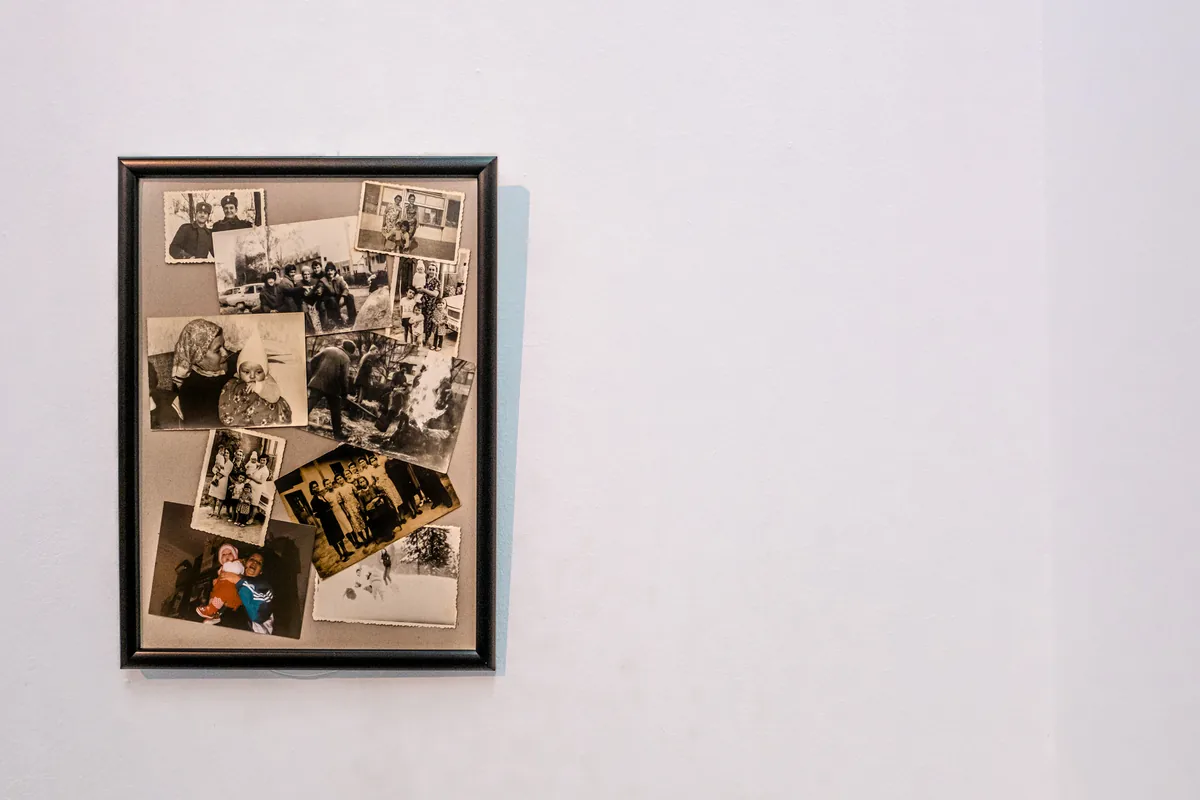 Framed collage of original family archival photographs on the gallery wall