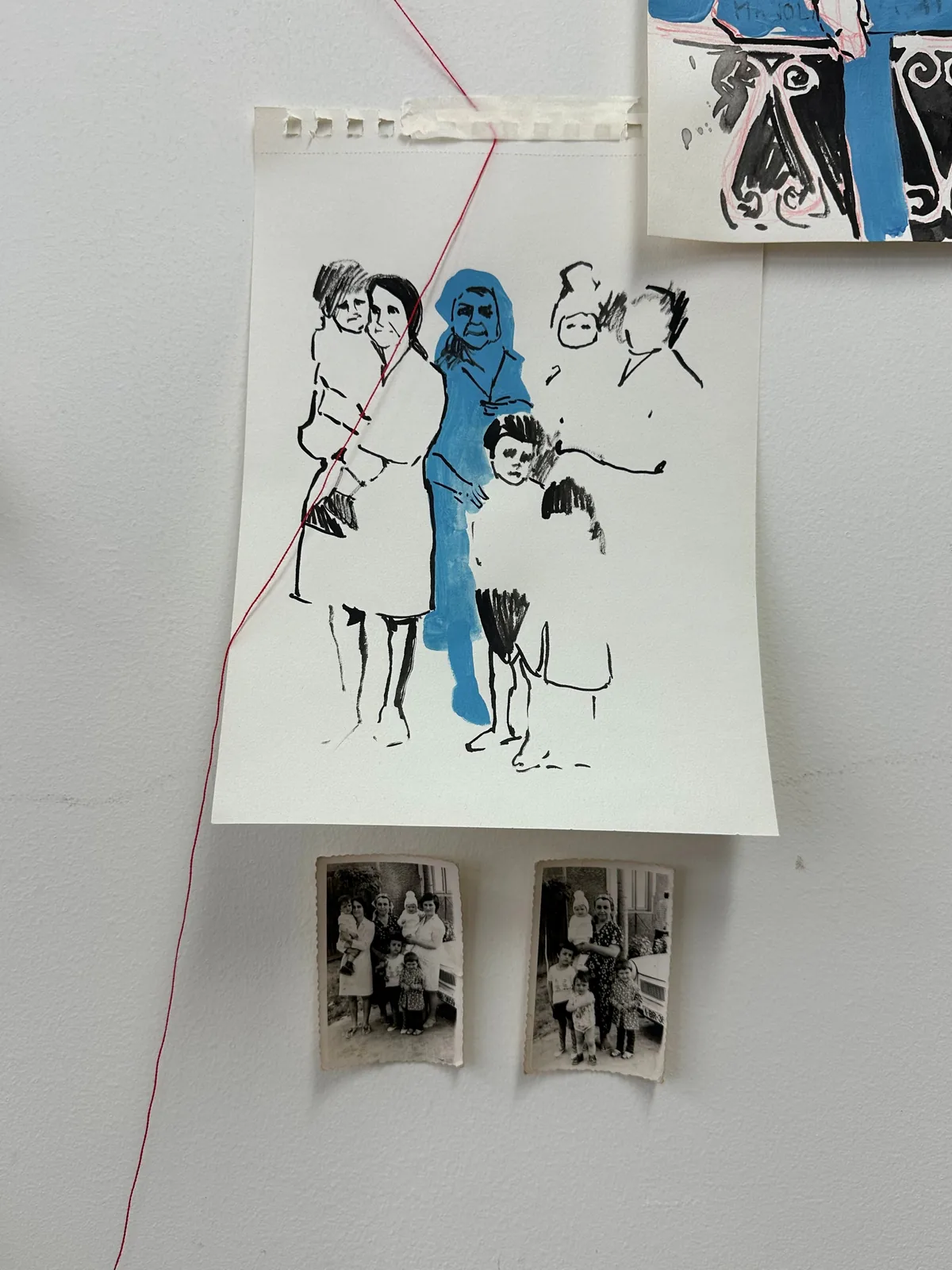 Ink and acrylic family drawing above two small archival photographs with descending red thread